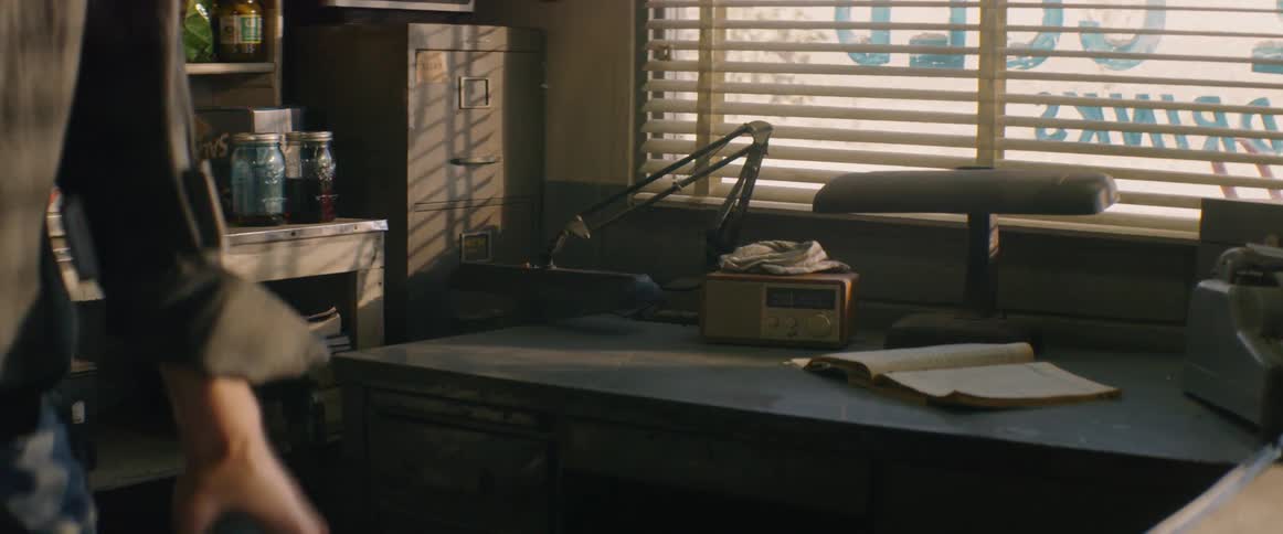 A handicapped man stands next to a desk