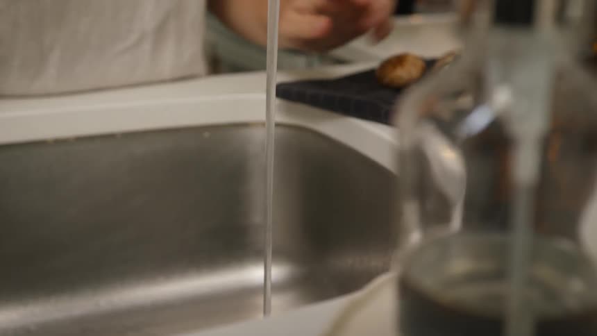 Person washes potatoes off in a sink