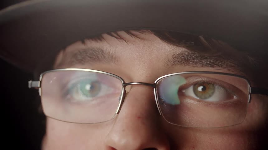 A man puts on a pair of glasses