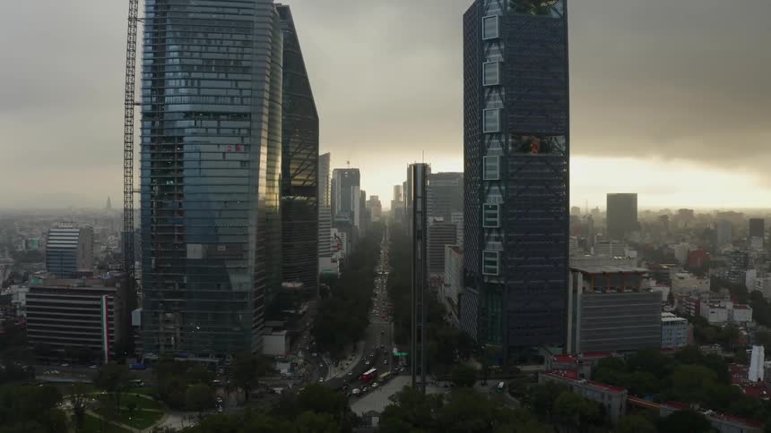 Tall city buildings at dusk with storm clouds