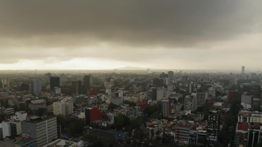 Clouds float above city buildings on an overcast day