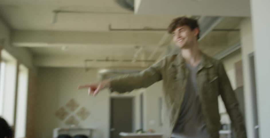 Three men and a woman playing a game and cheering each other on