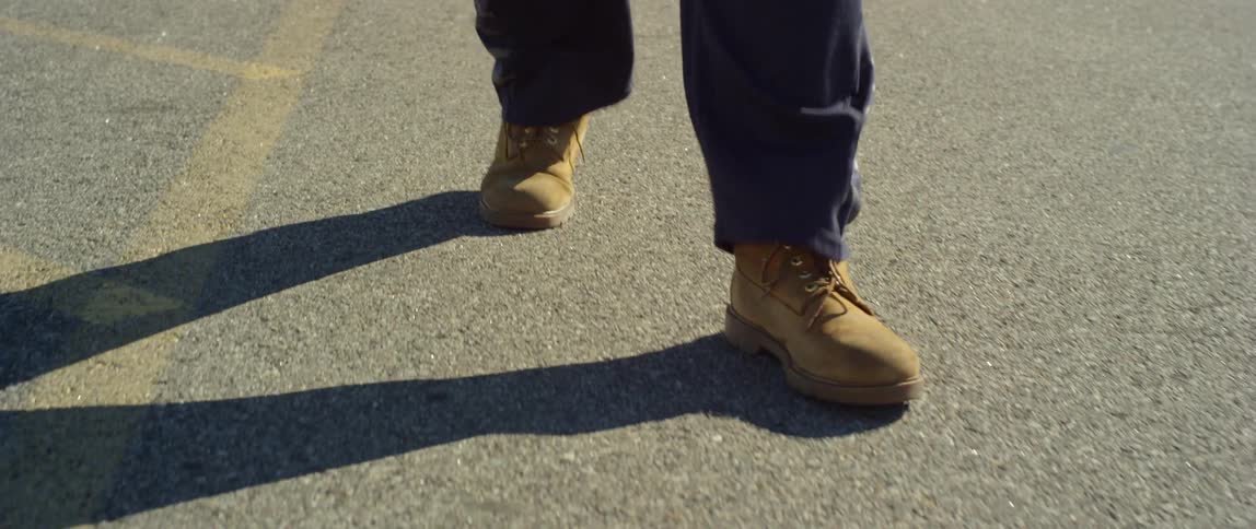 A person walking on the street on a bright day