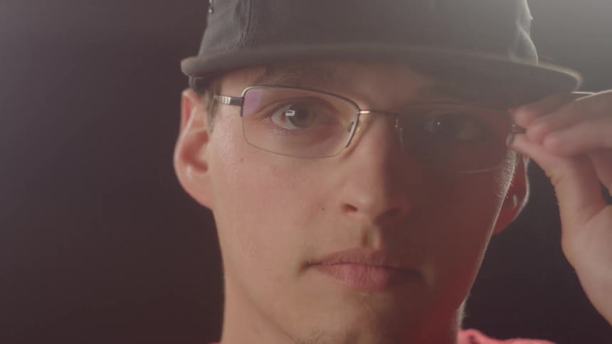 Man Putting On Glasses