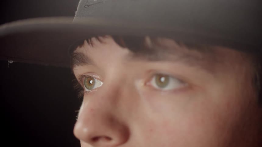 A man takes off his glasses and put it back on