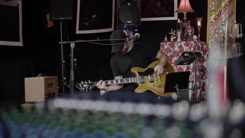 A man is playing guitar on the stage
