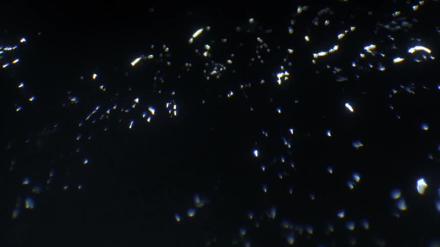 Light shines onto a dark reflective surface