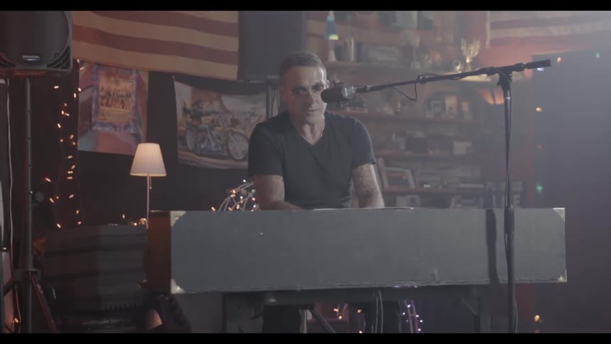 A musician sings while playing a keyboard