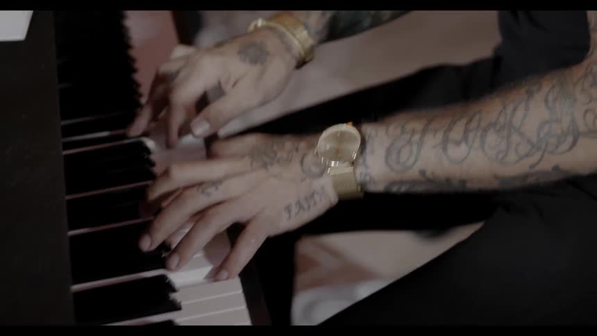 A person is playing keyboard in studio