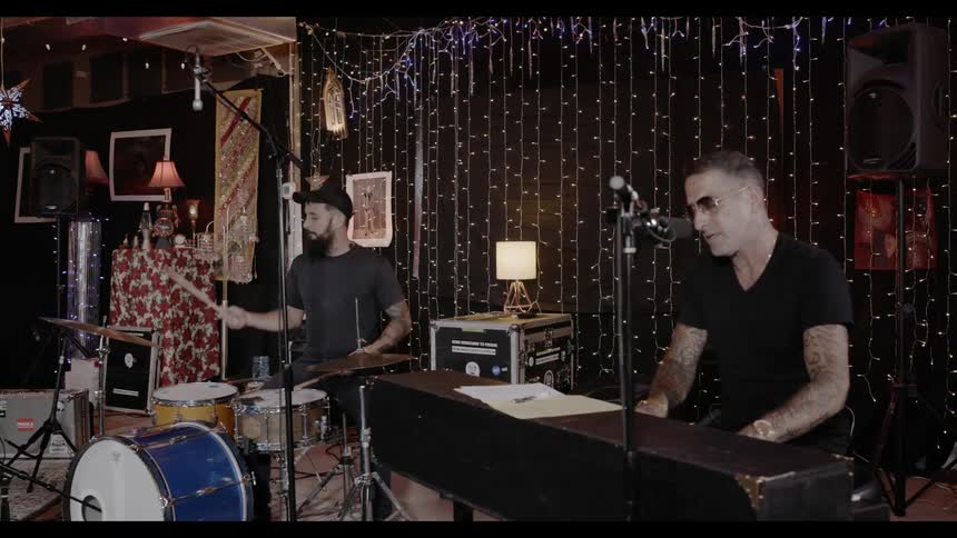 Pianist and drummer play their instruments indoors