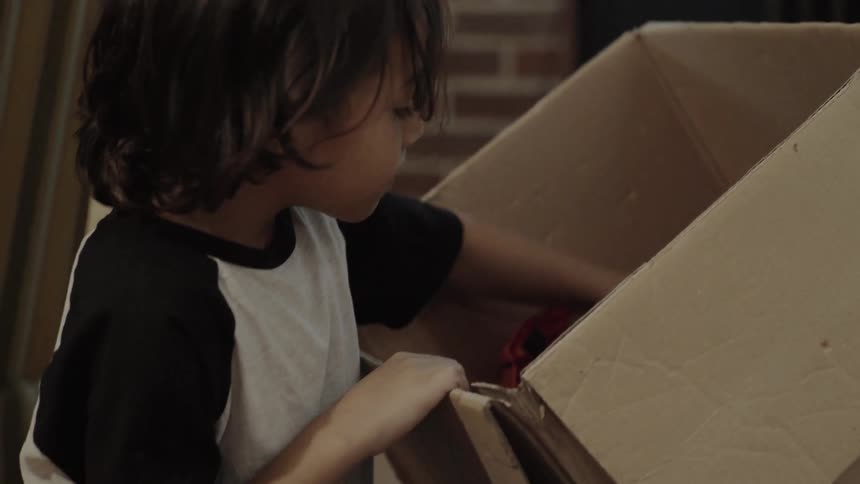 Child takes toys out of a box