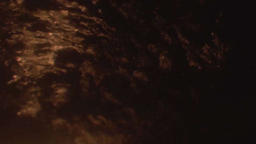 A flame burning below a charred product