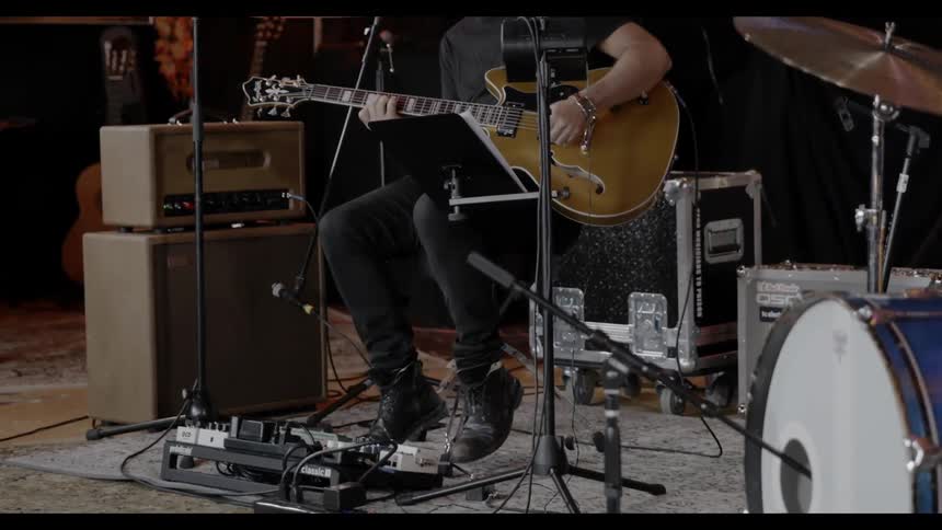 A man sitting and playing guitar