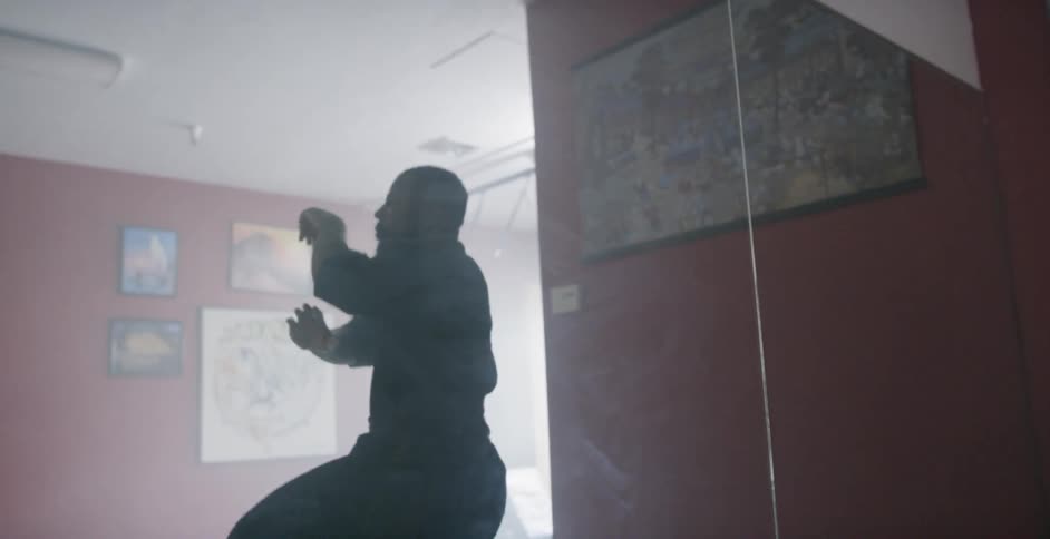 A man practices martial arts moves in a studio