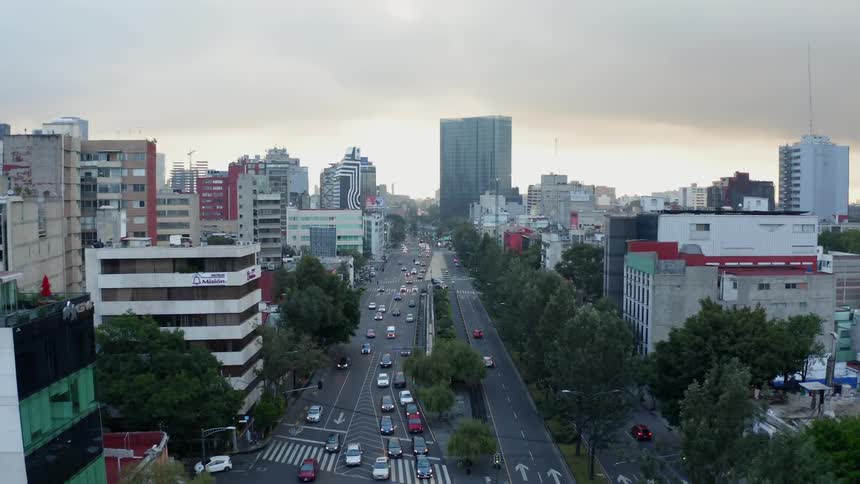 Busy city street full of cars with many buildings