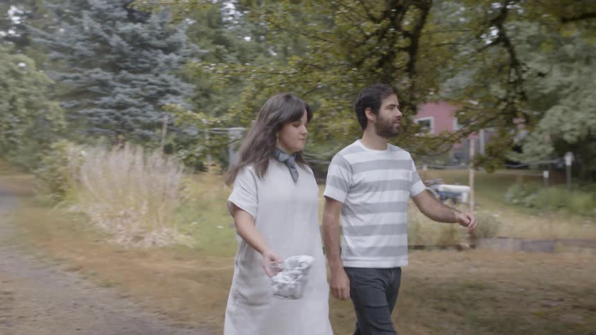 Woman and man walking down a dirt path