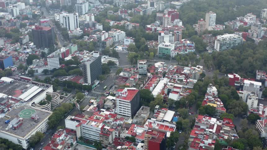 The city below is busy with moving vehicles
