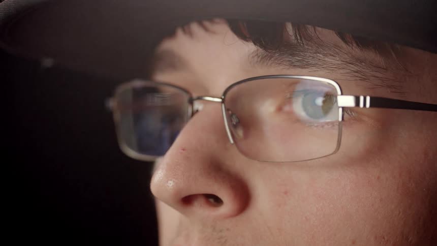 A man putting glasses on