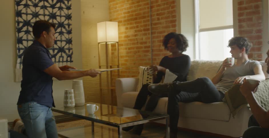 A group of people talking in a house