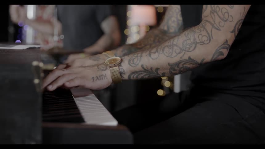 A person is playing keyboard in studio