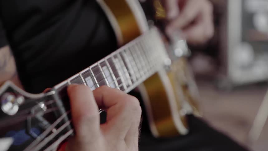 A person is playing guitar indoors