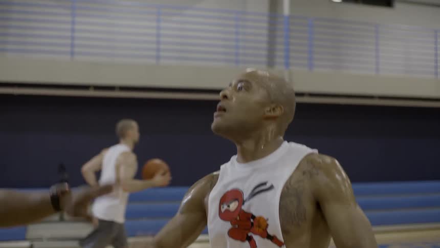 Men playing basketball in a gym