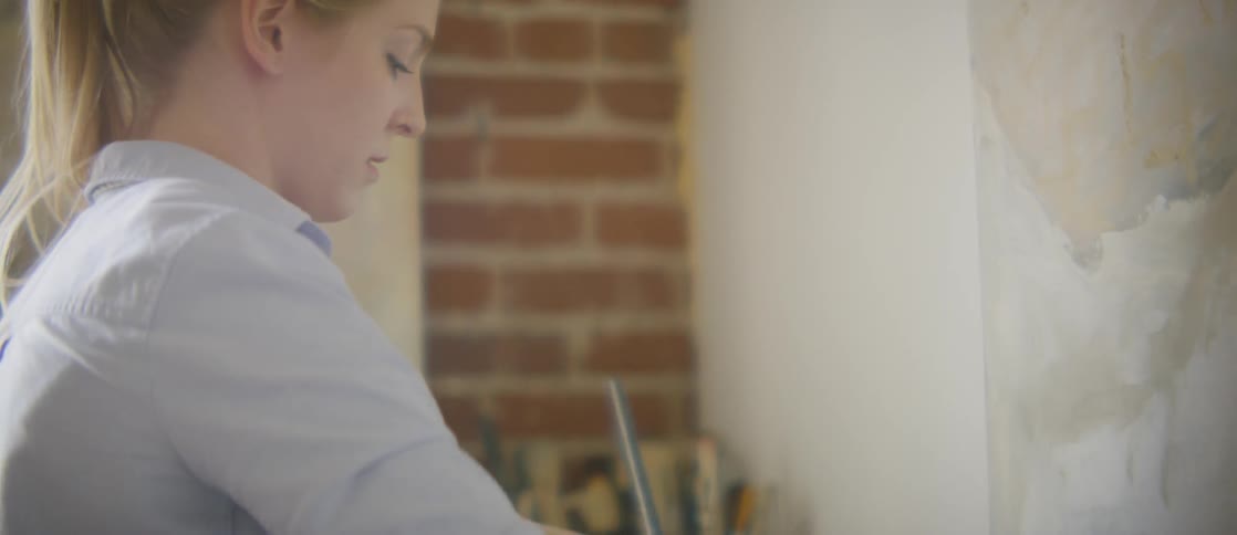 A woman is painting indoors