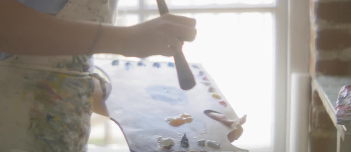 A woman using a paintbrush