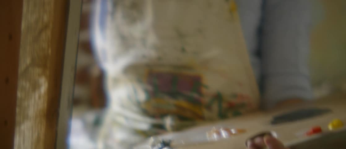 A person is painting indoors