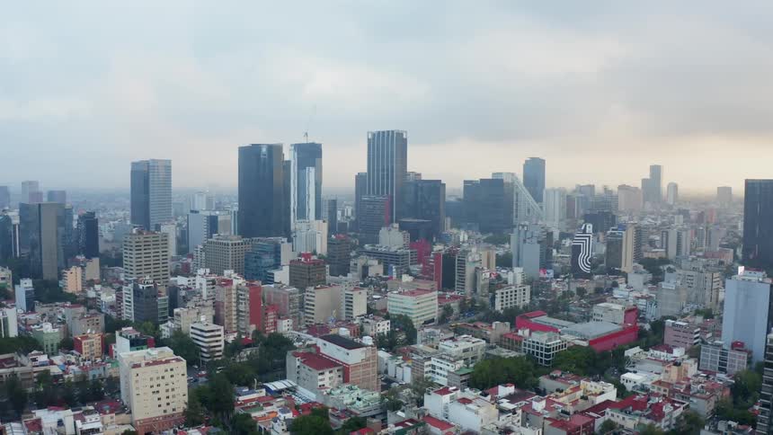 Skyscrapers stand in a city at sunset
