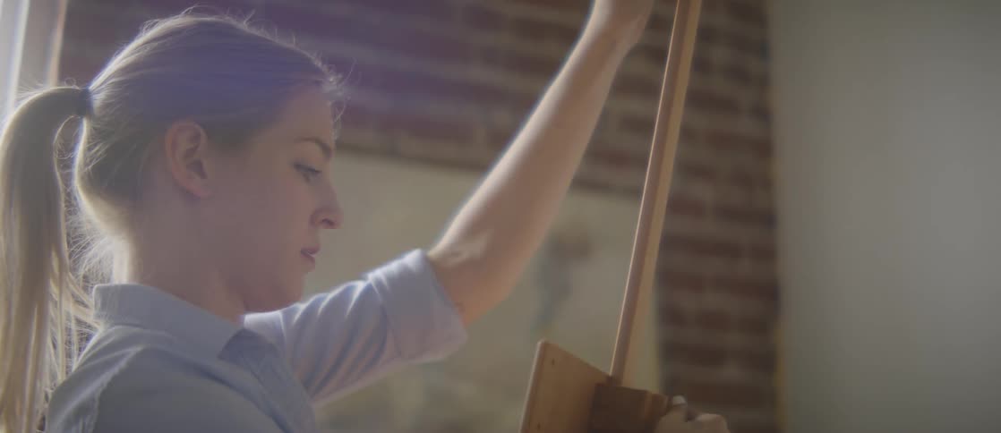 An artist sets up her workstation to start painting