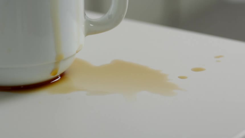 Cup with spilled coffee under it