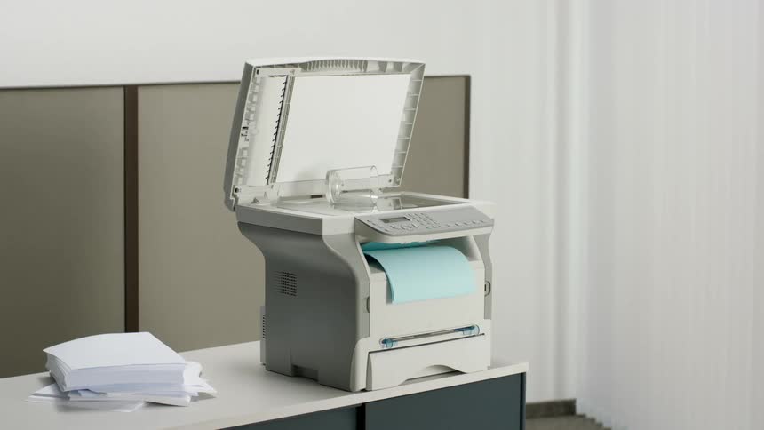 A spilled glass of water is being copied on the printer