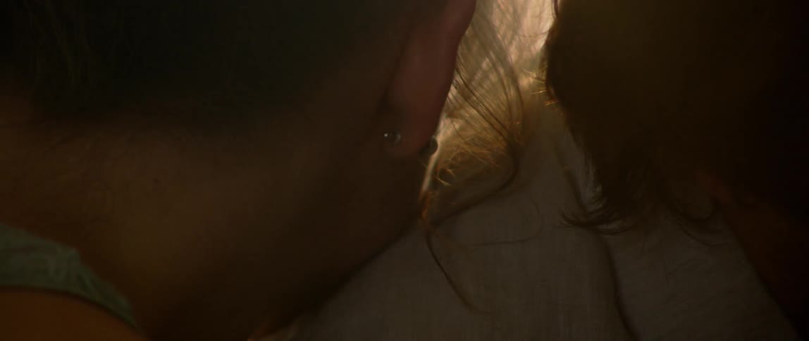 A woman's resting on a man's shoulder