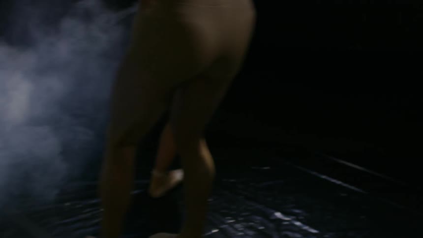 A male and female dancer spinning while powder floats into the air