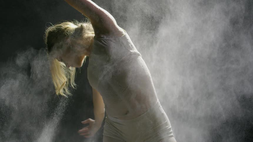 Woman dances as powder is thrown on her