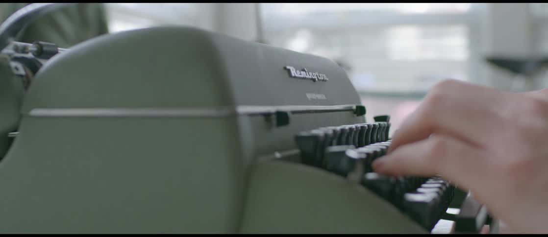 A person is typing on a typewriter