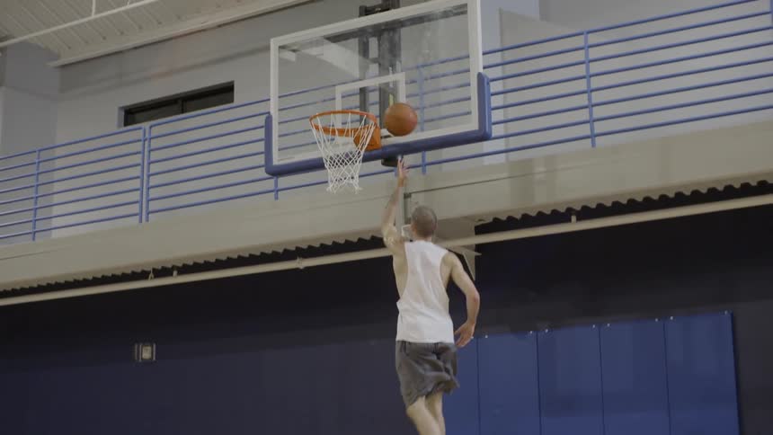 Man playing basketball in a gym