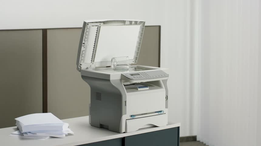 Copy machine on desk with glass on it