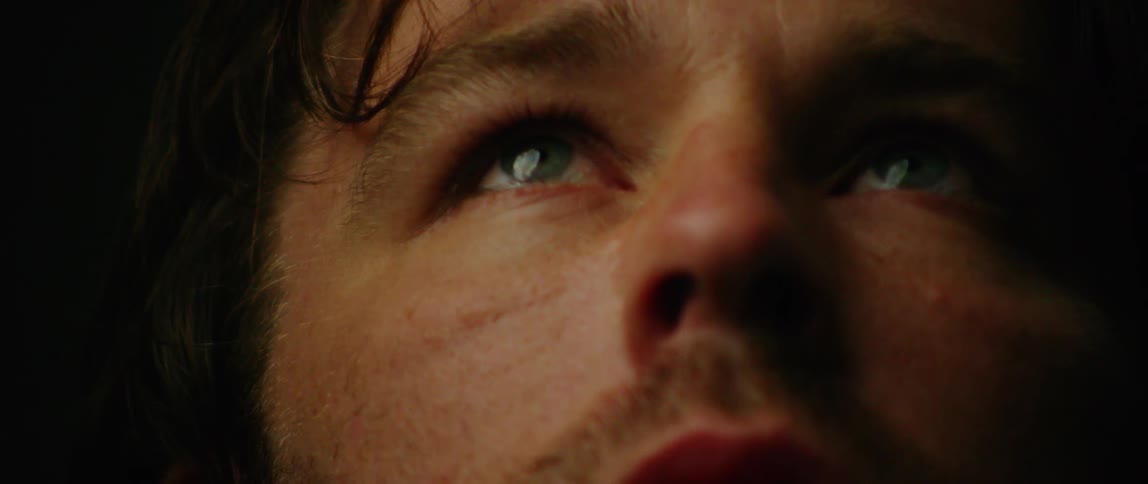 Man opens his eyes and looks up