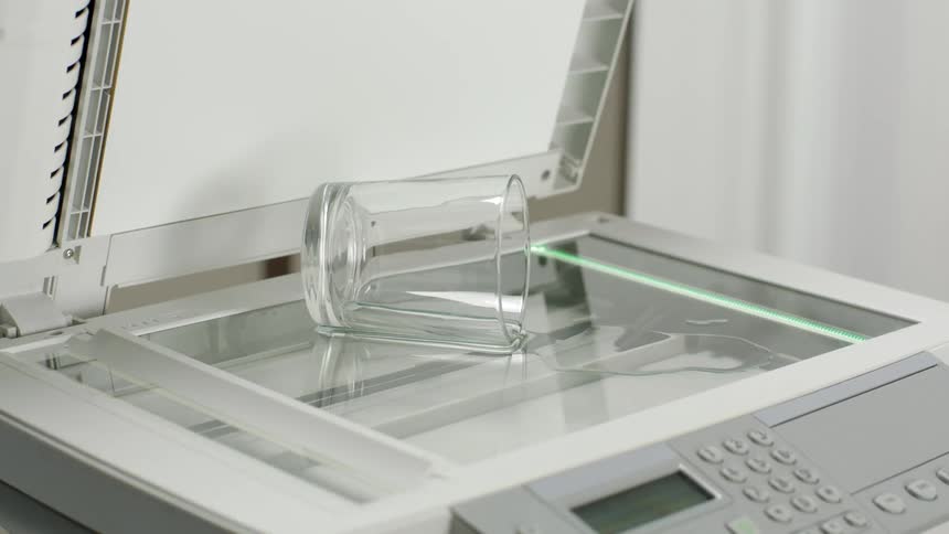 A glass of spilled water is being photocopied