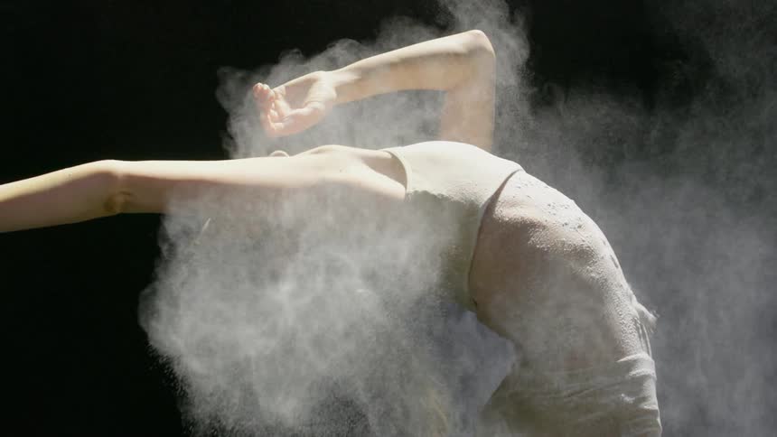 Powder is thrown onto a female dancer