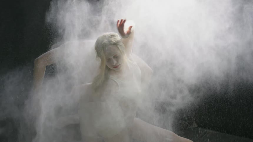 Powder is thrown onto two dancers