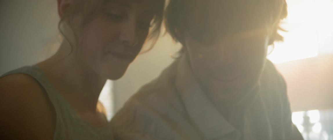 A young woman leans into her boyfriend