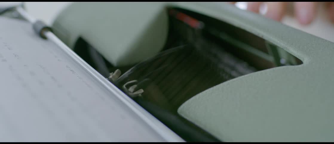 Closeup of the type heads on a typewriter moving as a person types