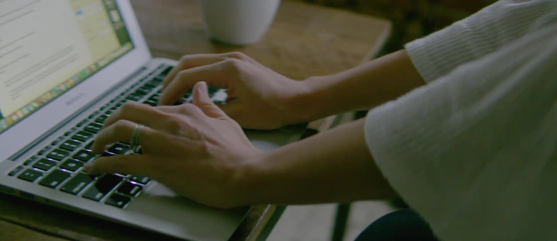 A person is typing on the laptop