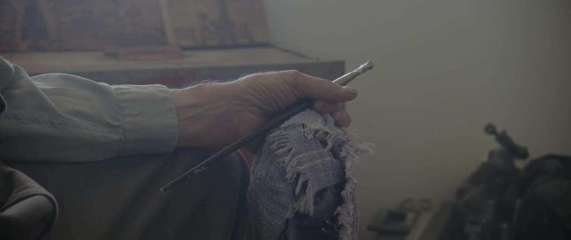 A person is holding a paintbrush