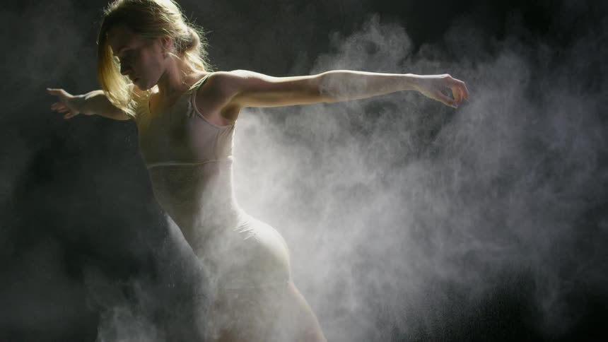 A woman dancing with flour being thrown