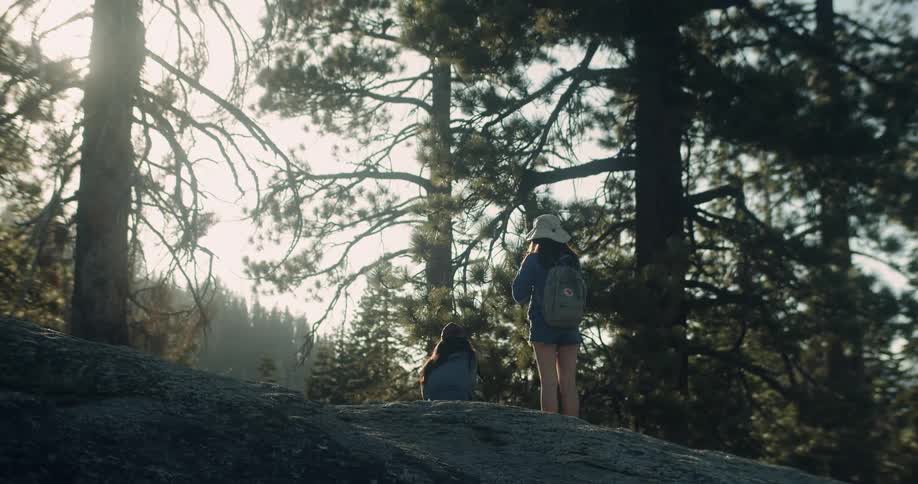 Two women hike in a forest