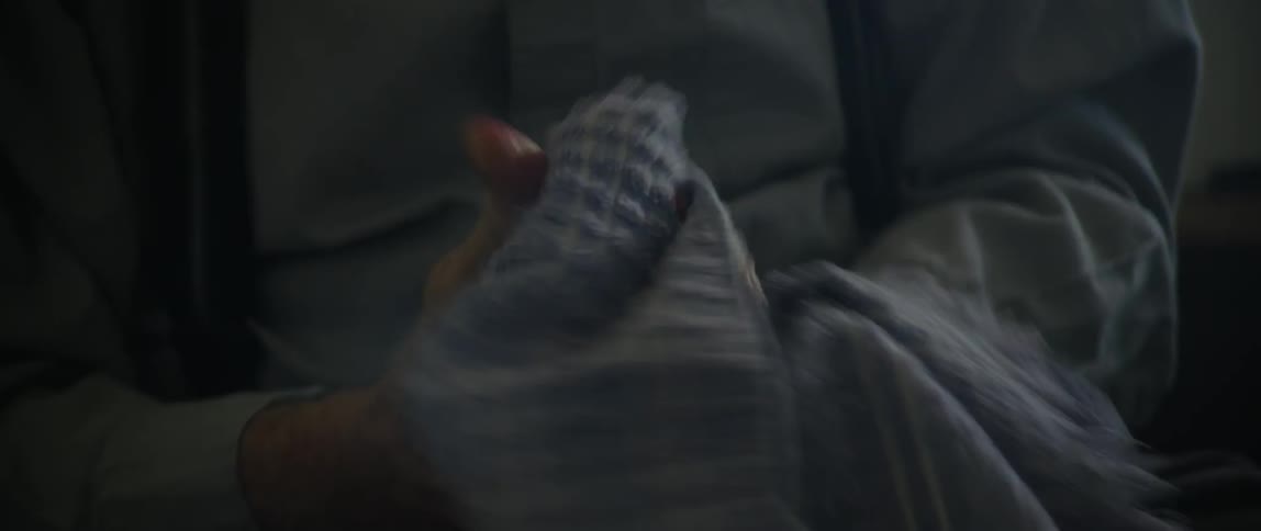 A man wiping paint off his hands onto a towel